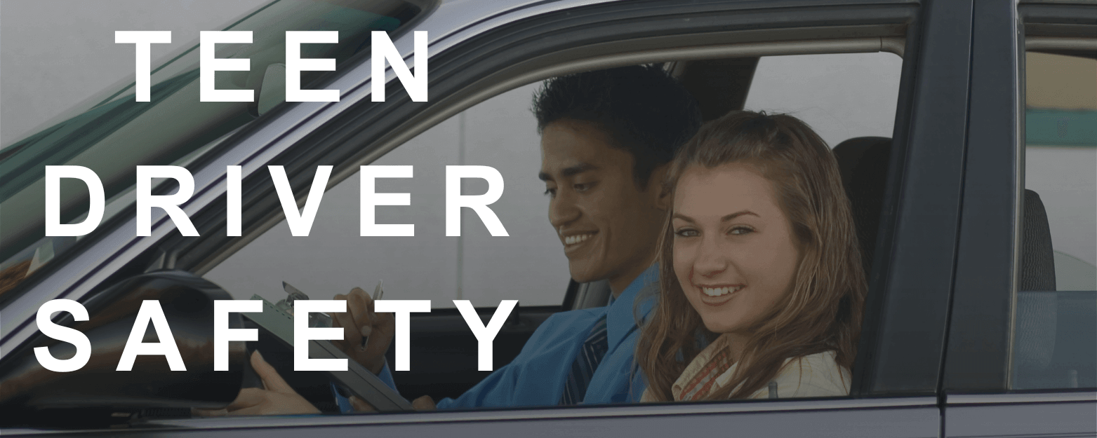 Teen driver smiling in car with driving instructor