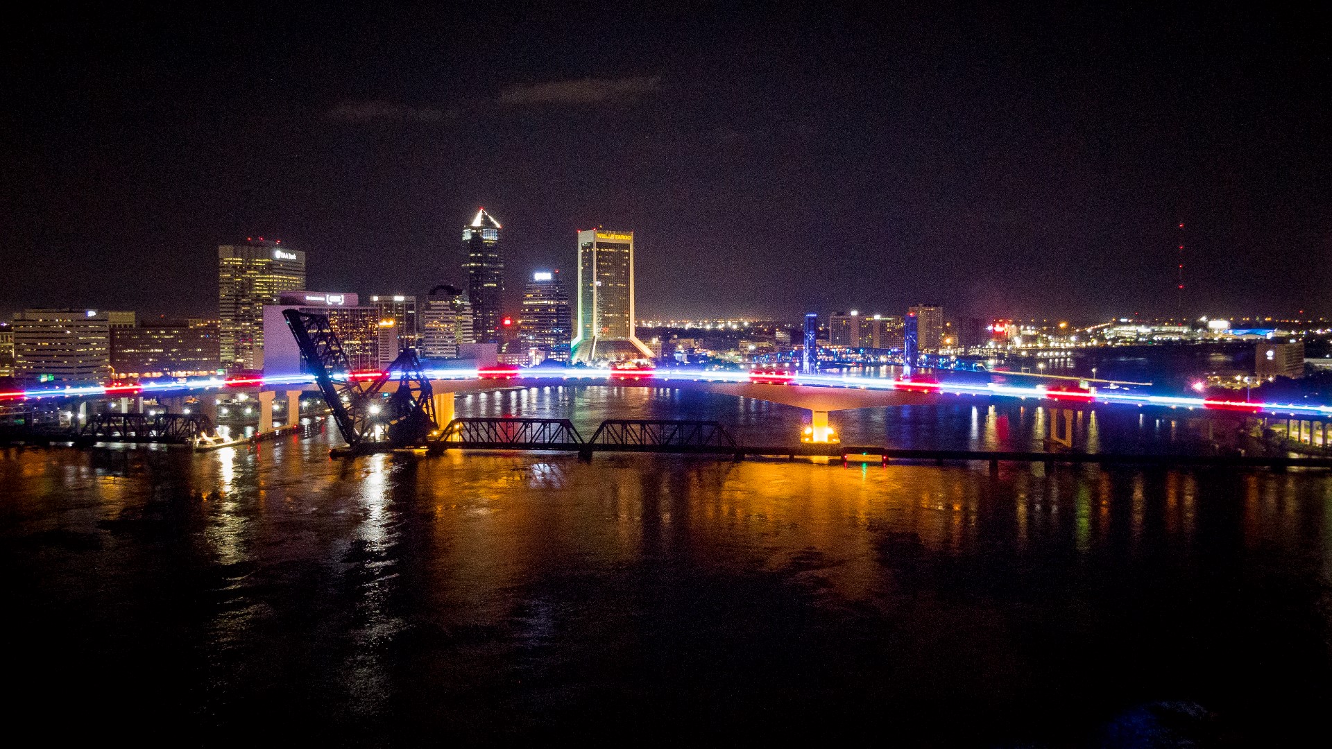 A Florida bridge lit with red, white, and blue lights.