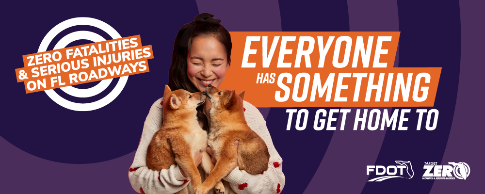A woman smiles holding two small dogs with the text