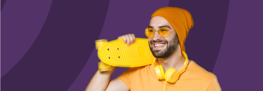 guy in orange beanie with yellow skateboard and yellow head phones.
